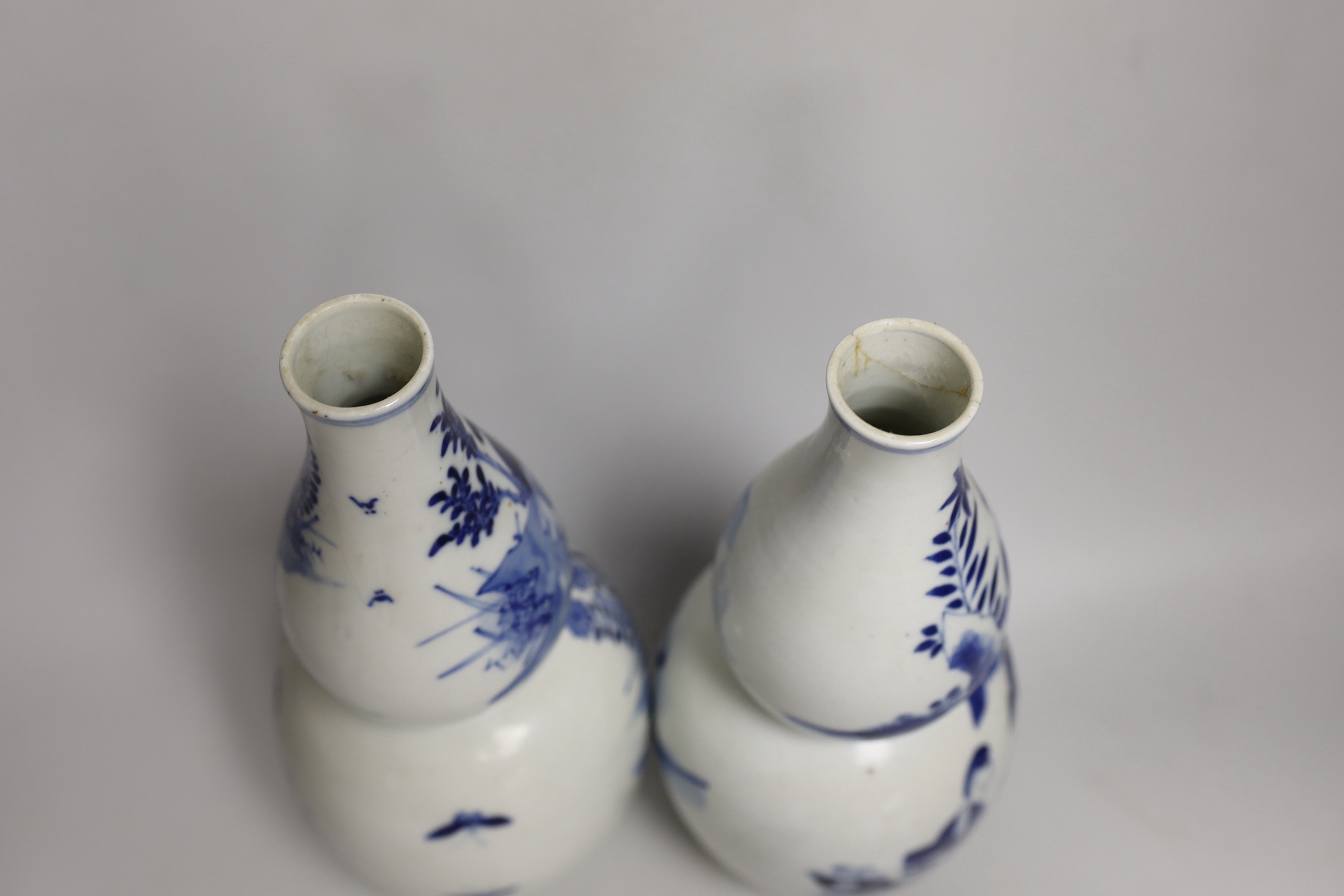 A pair of 19th century Chinese blue and white double gourd vases, 26cm high (a.f.)